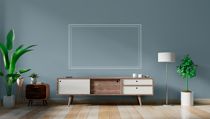 Front view of wooden and white TV stand against blue grey wall in living room with wooden floors and decorated with potted plants